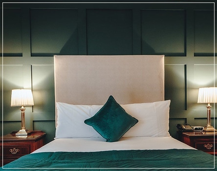 Elegant bedroom with cozy lighting and green features.