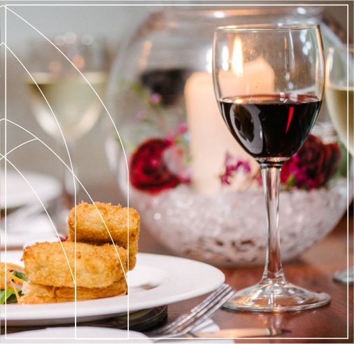 A glass of wine paired with a delicious meal