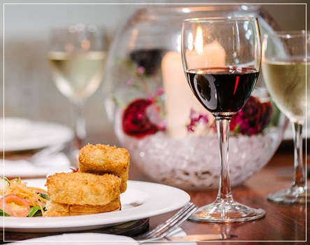 A glass of wine paired with a delicious meal