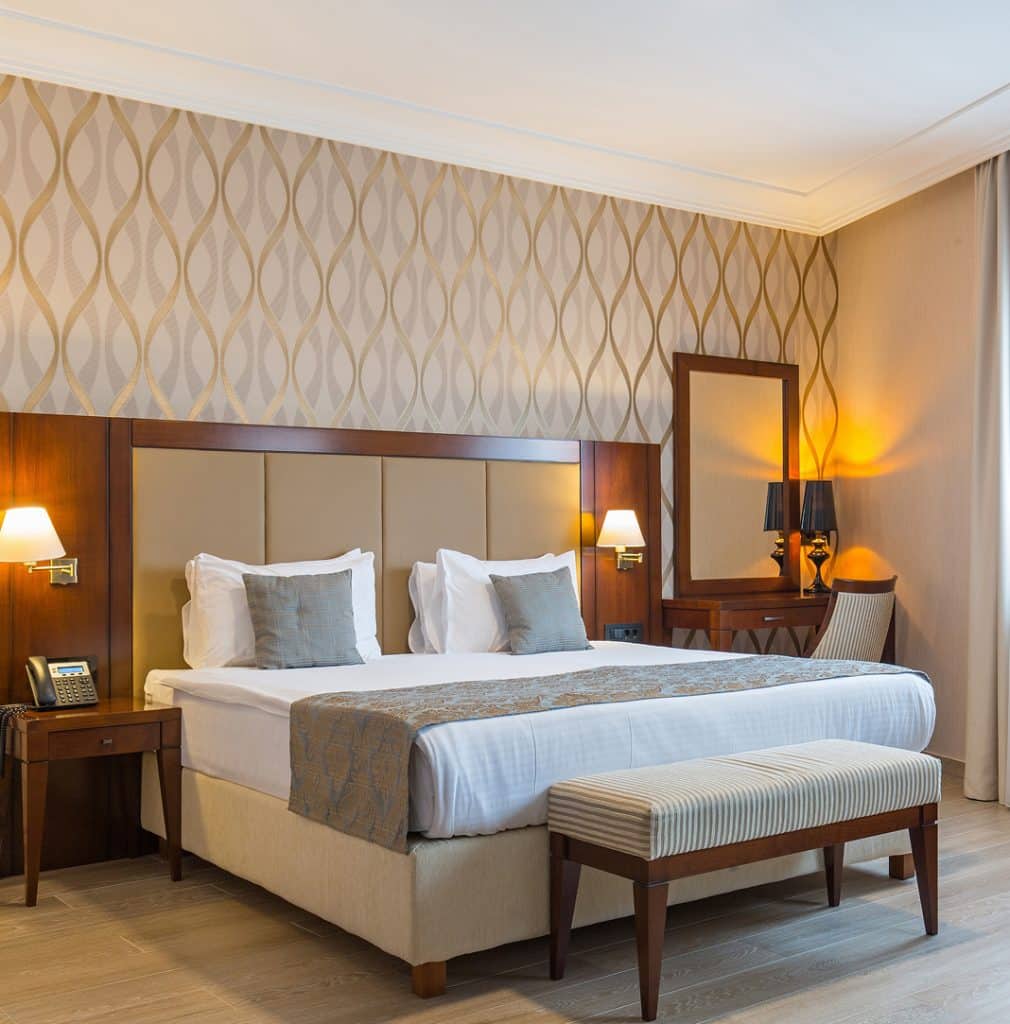 Hotel room with a bed, nightstands, and a dressing table