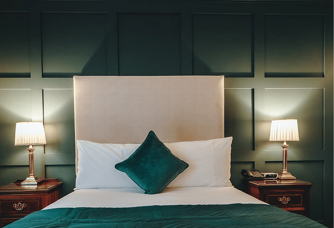 Comfortable bed with pillows and blankets